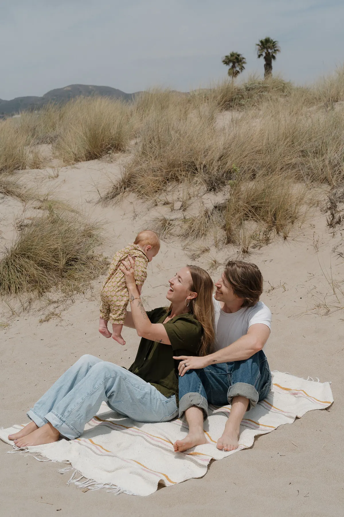 Kyle, Ceci, and their baby Joy on a Ventura beach