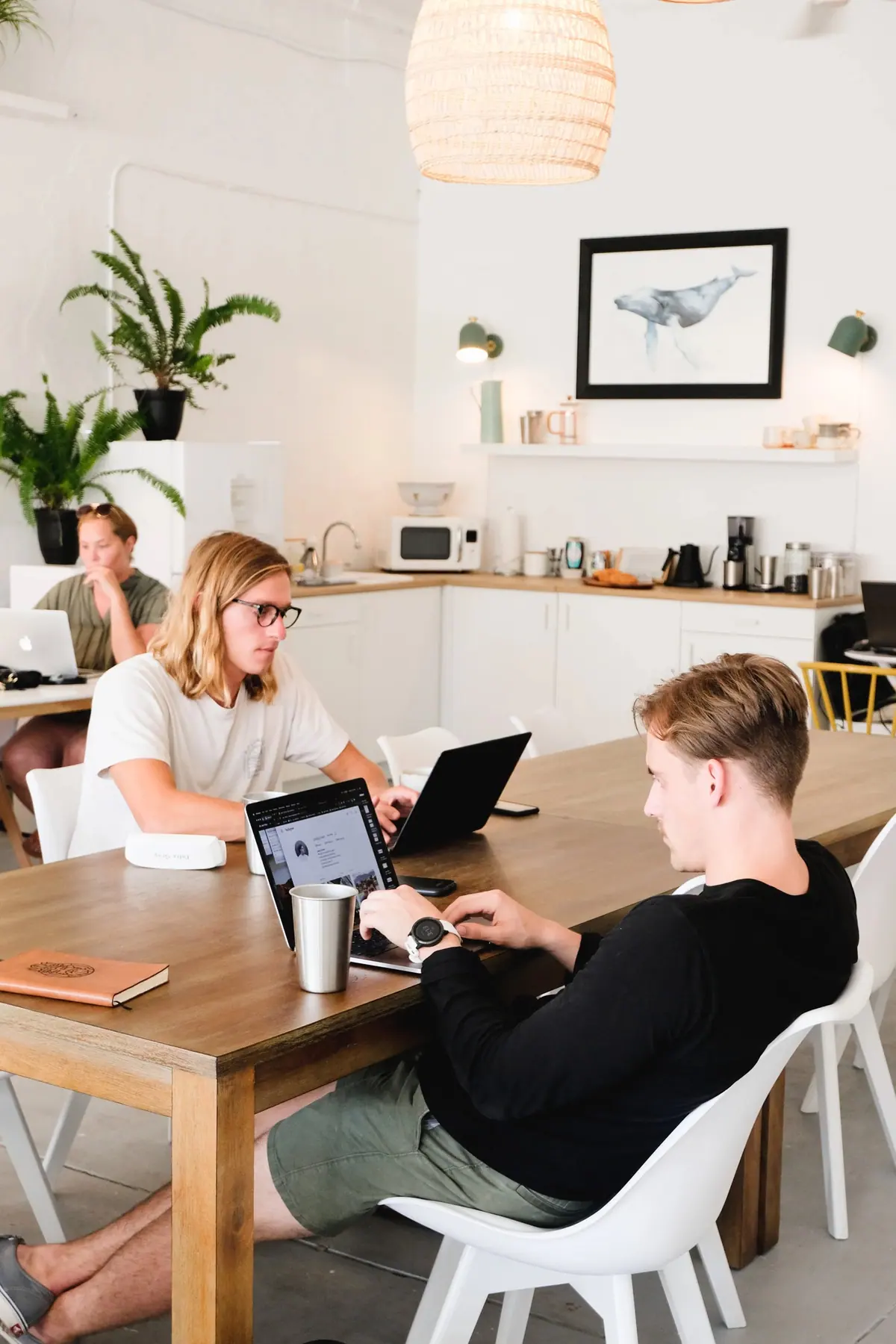 People working together at Coastal Coworking's shared table